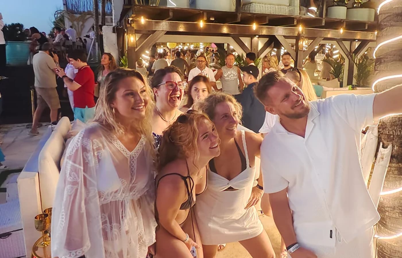 Guests taking a selfie at an evening party