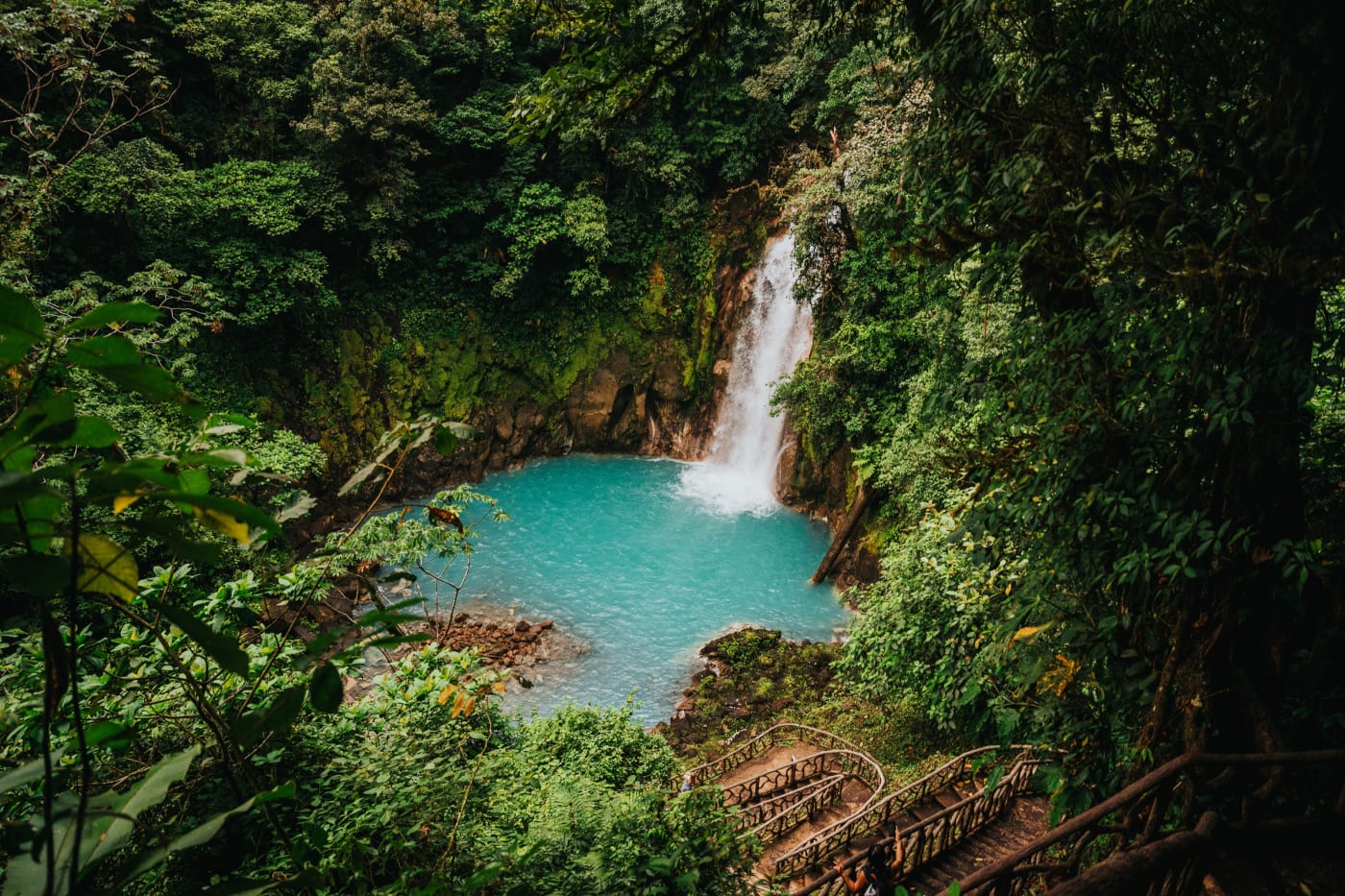 A waterfall into a turquoise pool in the Costa Rican rainforest